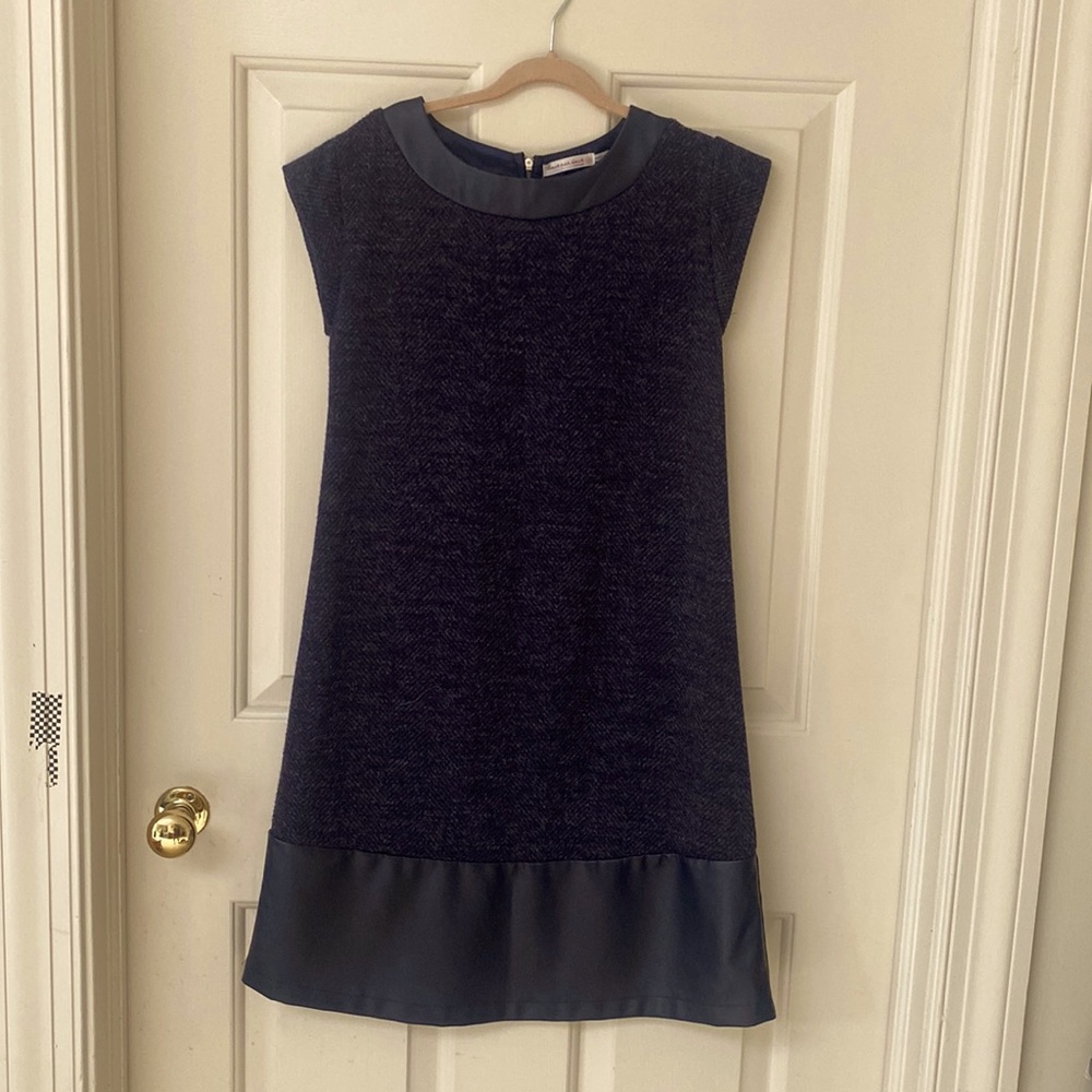 Wool short sleeve dress with leather bottom and collar trim.